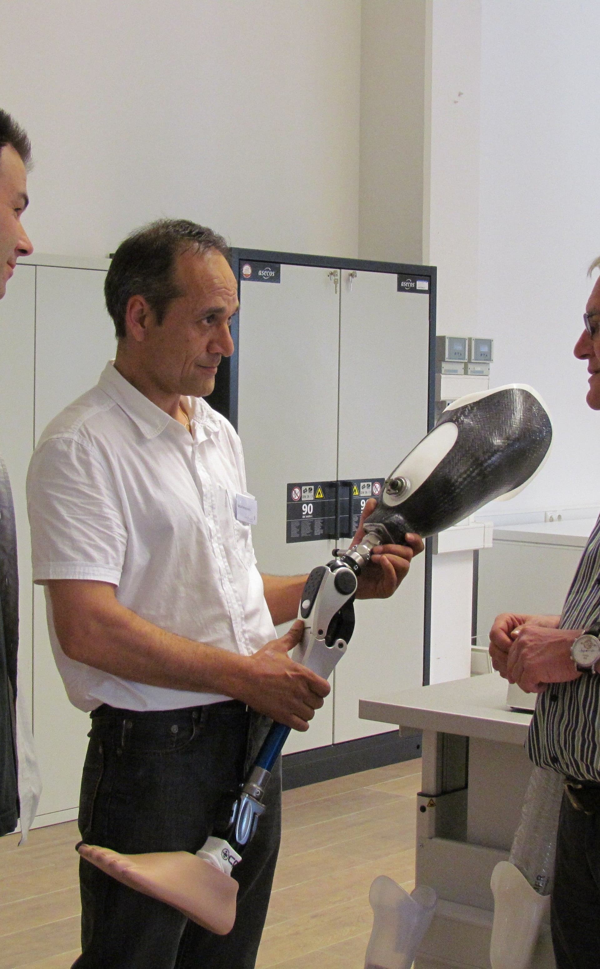 Founder Abdul Wali Nawabi training in Germany, holding an advanced prosthetic limb